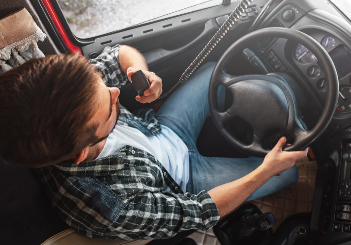 truck-driver-talking-by-cb-radio-system-in-his-veh-2023-11-27-04-53-51-utc@2x